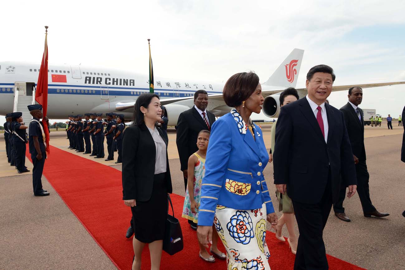 Arrive.jpg - President of the PeopleÕs Republic of China, His Excellency Mr Xi Jinping arrives at Waterkloof AFB ahead of the State Visit. Later President Jinping will attend FOCAC. The boy who handed President Jinping flowers is Dzunani Manzini from Thatchfield Curro School Pretoria. Picture byline: Jacoline Schoonees. President Zuma to receive the President of the PeopleÕs Republic of China on a State Visit to South Africa His Excellency President Jacob Zuma will on Wednesday, 02 December 2015, host the President of the PeopleÕs Republic of China, His Excellency Mr Xi Jinping, on a State Visit to South Africa. During the State Visit of President Jacob Zuma to China in December 2014, the two countries concluded the ÒFive-to-Ten Year Strategic Programme for Cooperation between the Republic of South Africa and the PeopleÕs Republic of ChinaÓ. The two leaders will engage in bilateral talks where they will look at the progress made thus far on the Strategic Programme with specific reference to the six priority areas identified for 2015, namely: ´Alignment of industries to accelerate South AfricaÕs industrialization process; ´ Enhancement of cooperation in Special Economic Zones (SEZs); ´ Enhancement of marine cooperation; ´ Infrastructure development ´ Human resources cooperation; and ´ Financial cooperation. South AfricaÕs relations with China are at the level of a Comprehensive Strategic Partnership (CSP). The Beijing Declaration on the Establishment of a Comprehensive Strategic Partnership encapsulates all facets of South AfricaÕs relations with China, where China has committed to the respective developmental objectives. The focus of the State Visit will, therefore, be on economic and trade relations between the two countries. Total trade between South Africa and China experienced an upward trajectory since 2009, growing from R118 billion to R271 billion by the end of 2013. While there is a trade imbalance between China and South Africa, both countries have im